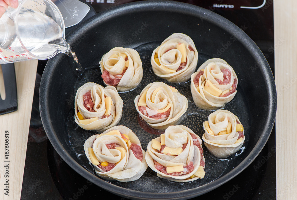 close-up of the hands of a chef in a professional kitchen cooking rose flower shape dumpling, chines