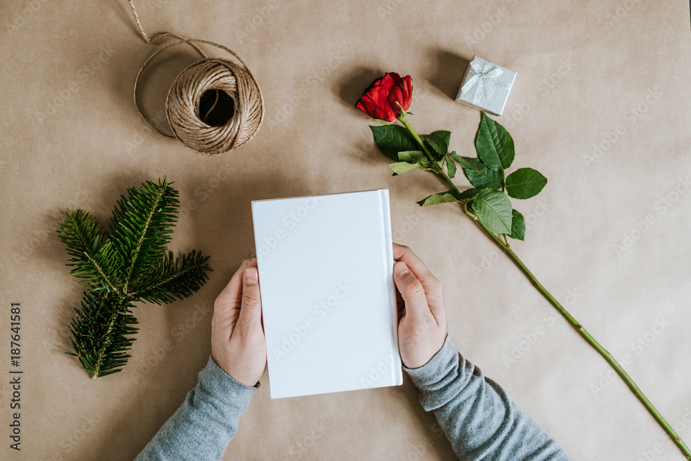 Male hands packing a present for girl and mother womens day.