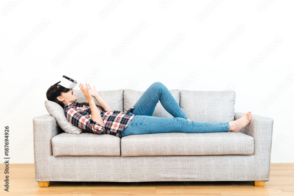 happy cheerful woman lying down on sofa relaxing