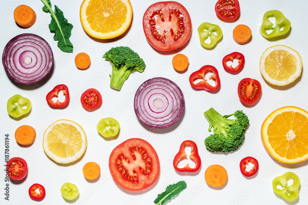 Assorted sliced vegetables and fruits on white background.  Flat lay. Food vegan concept.