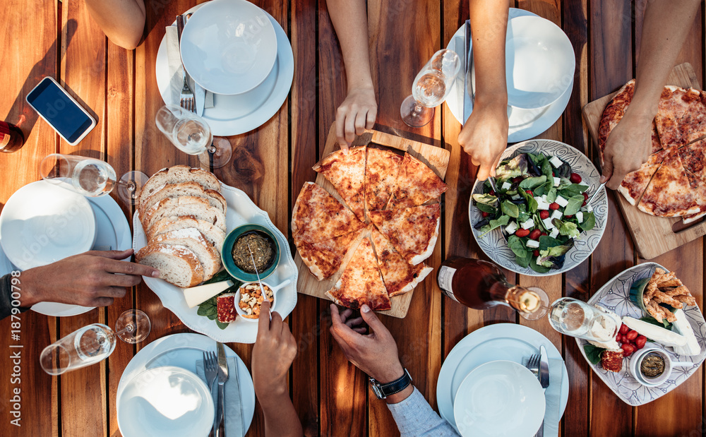 Friends having pizza at party