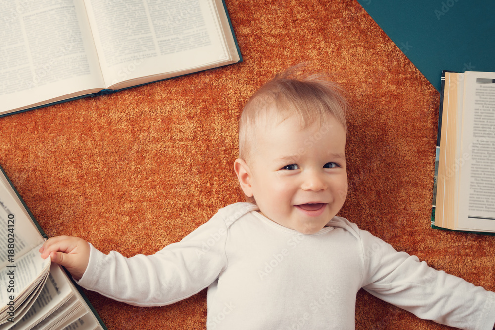 One year old baby with spectackles and books