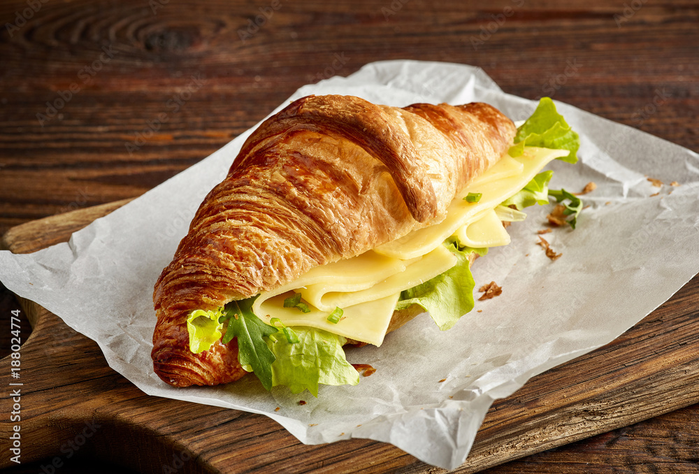 Croissant sandwich with cheese and salad