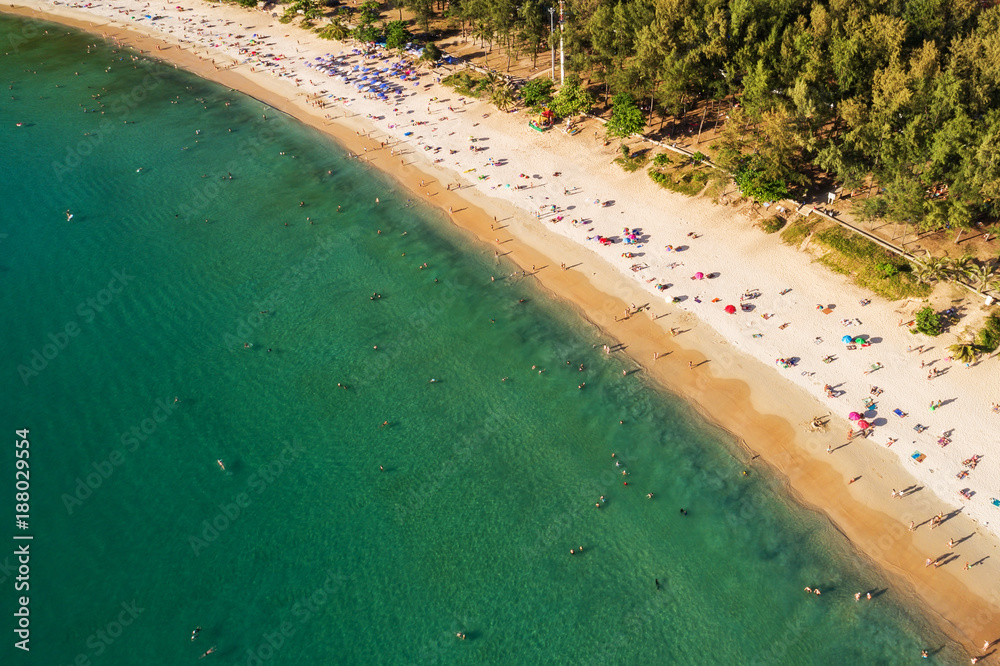 Summer image of beautiful and paradise beach with umbrellas and clear turquoise sea. Vacation on a t