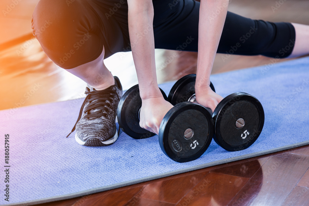 closeup hand hold dumbbell in fitness health concept