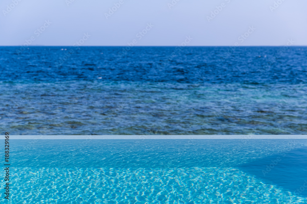 Outdoor swimmimg pool and blue sea