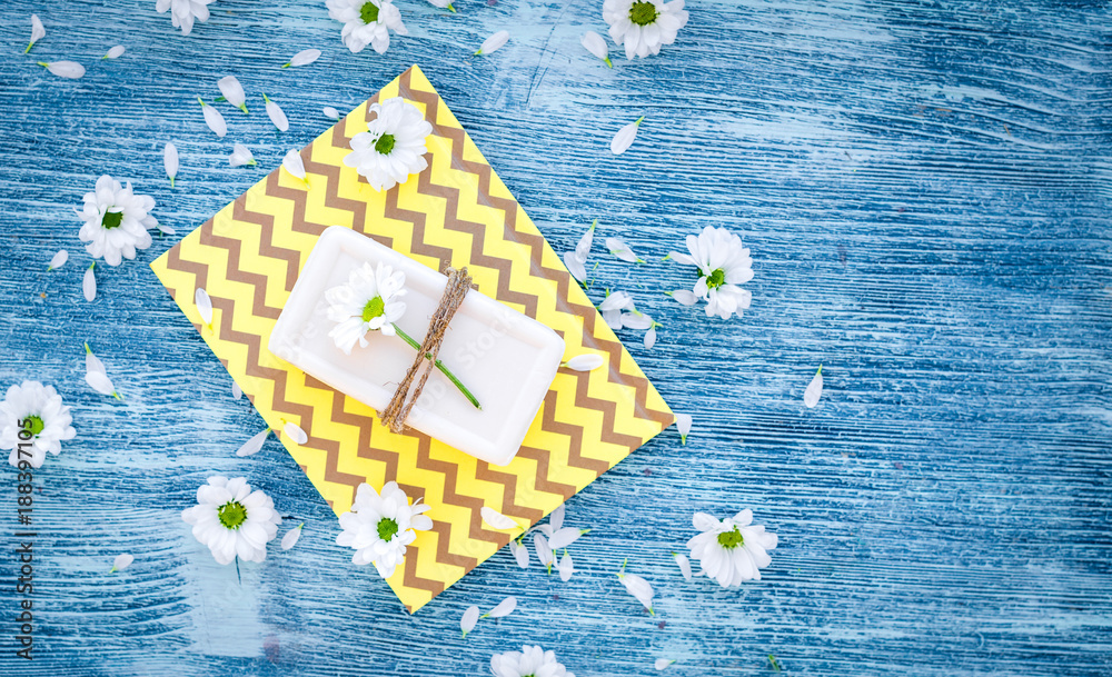 organic cosmetics with camomile on blue background top view