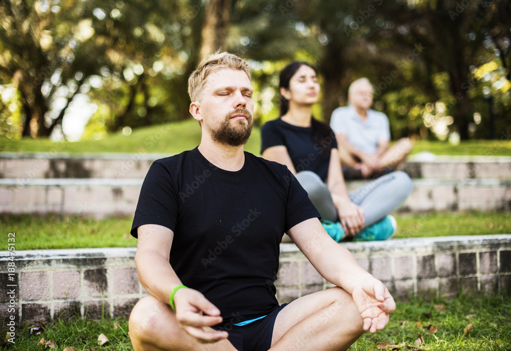 People doing yoga at the park