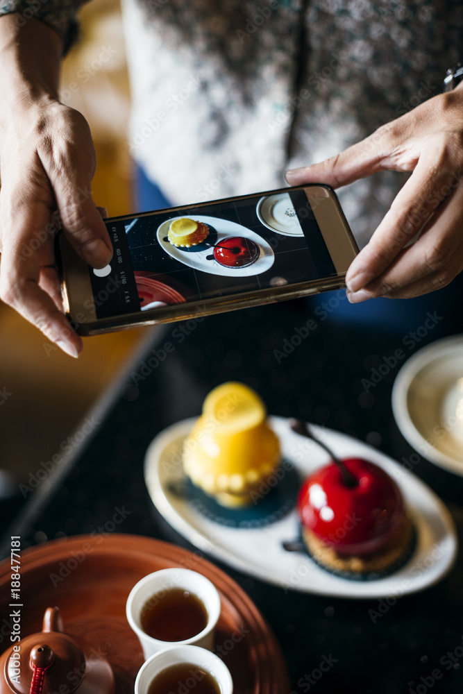 Woman taking a photo of her food