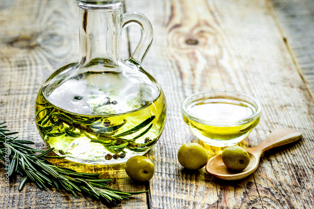 jar with oil with olives on wooden table background mock up