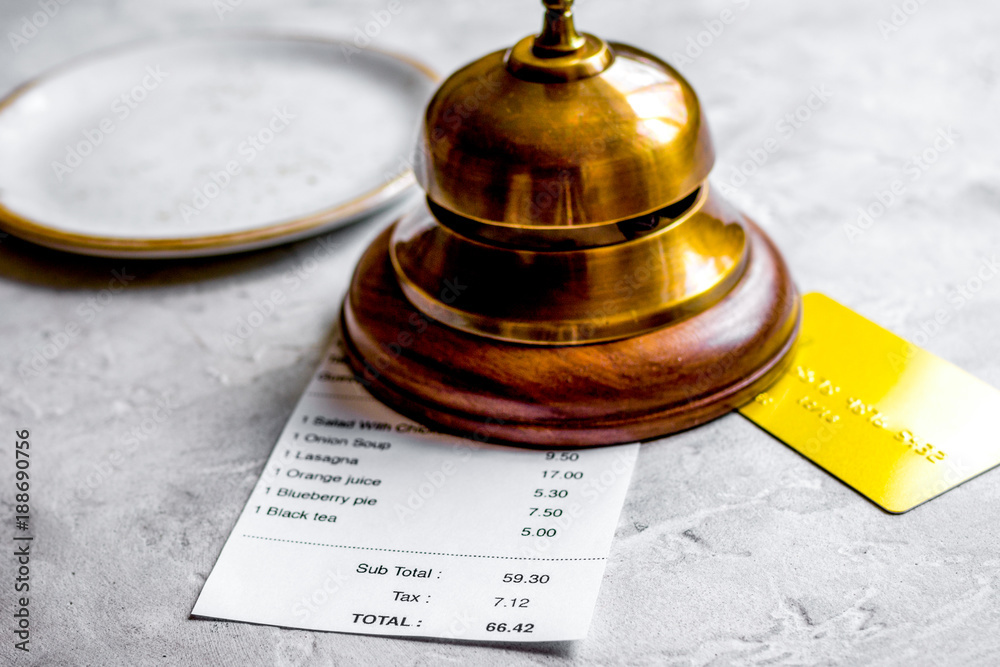 paying check for lunch in cafe with credit card on stone table b