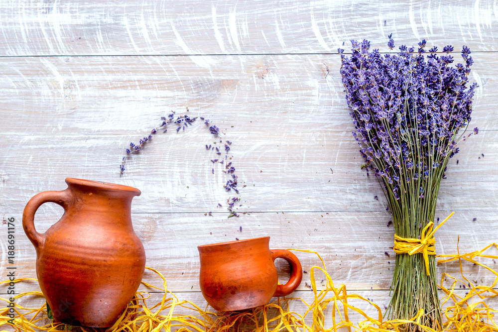 laveder composition with jar, cup, straw on rustic background to