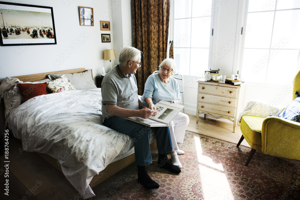 Senior couple looking at family photo album