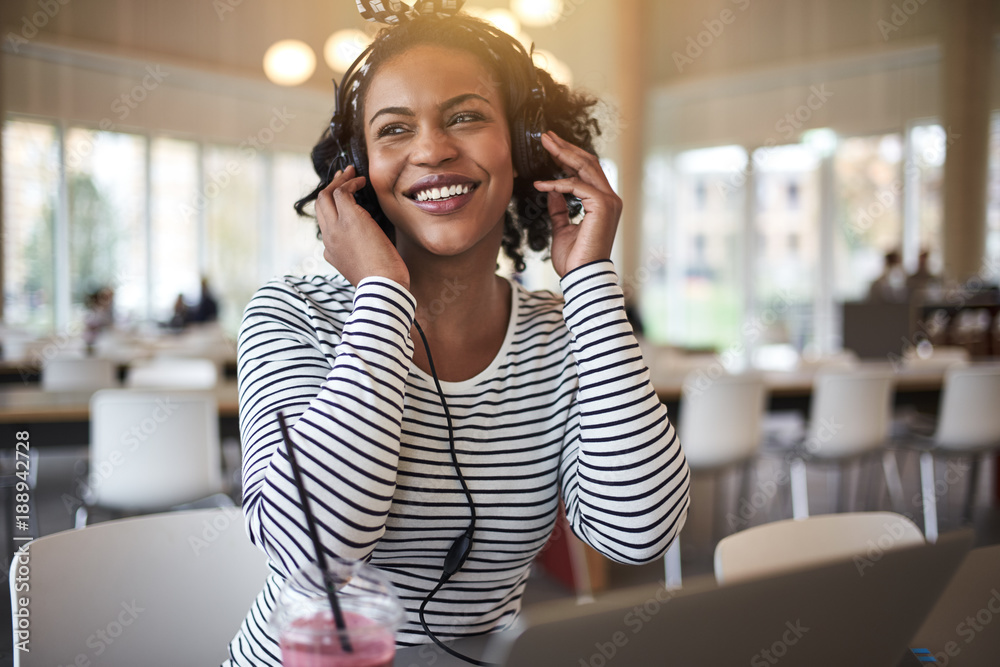 Young college student listening to music and studying between cl