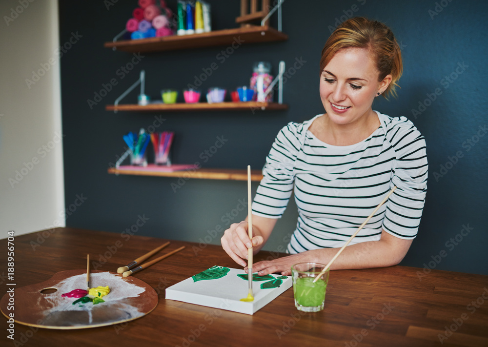 Creative female painting at desk