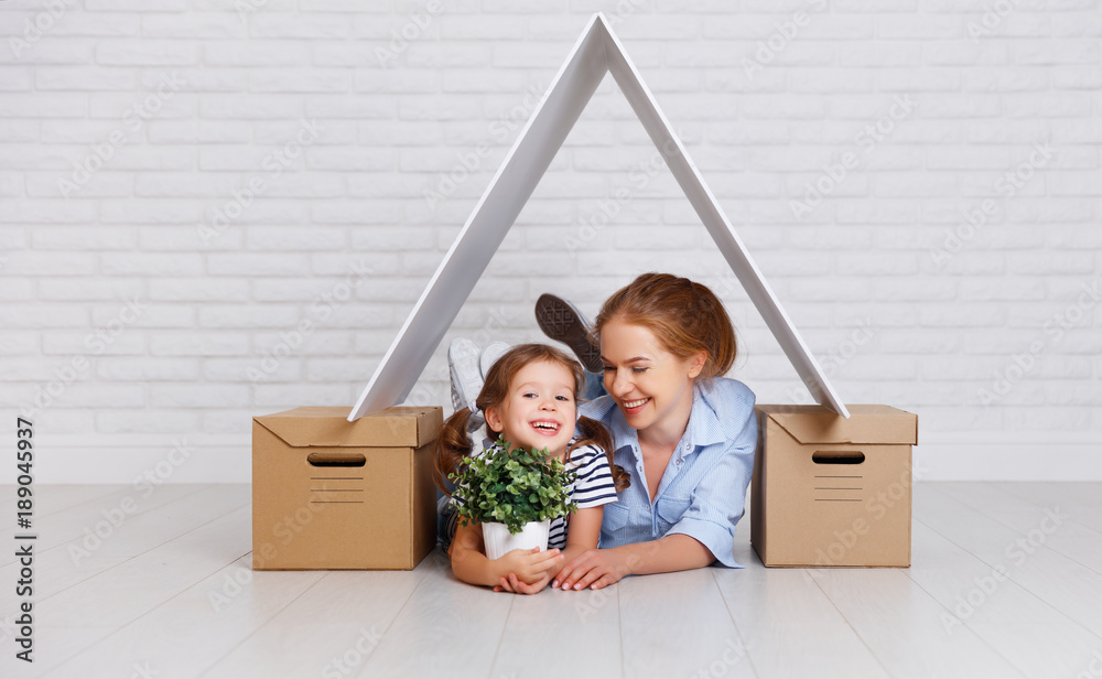 concept of housing, mortgage and relocation family mother and child with roof and boxes