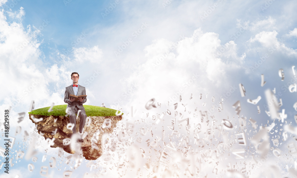 Young businessman or student studying the science and symbols fly around