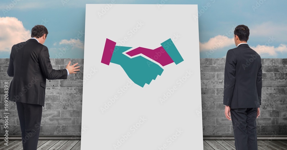 Businessmen standing by handshake icon on white board