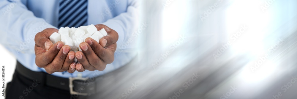 Sugar cubes in hands of businessman