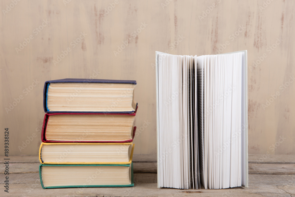 Education and reading concept - group of colorful books on the wooden table