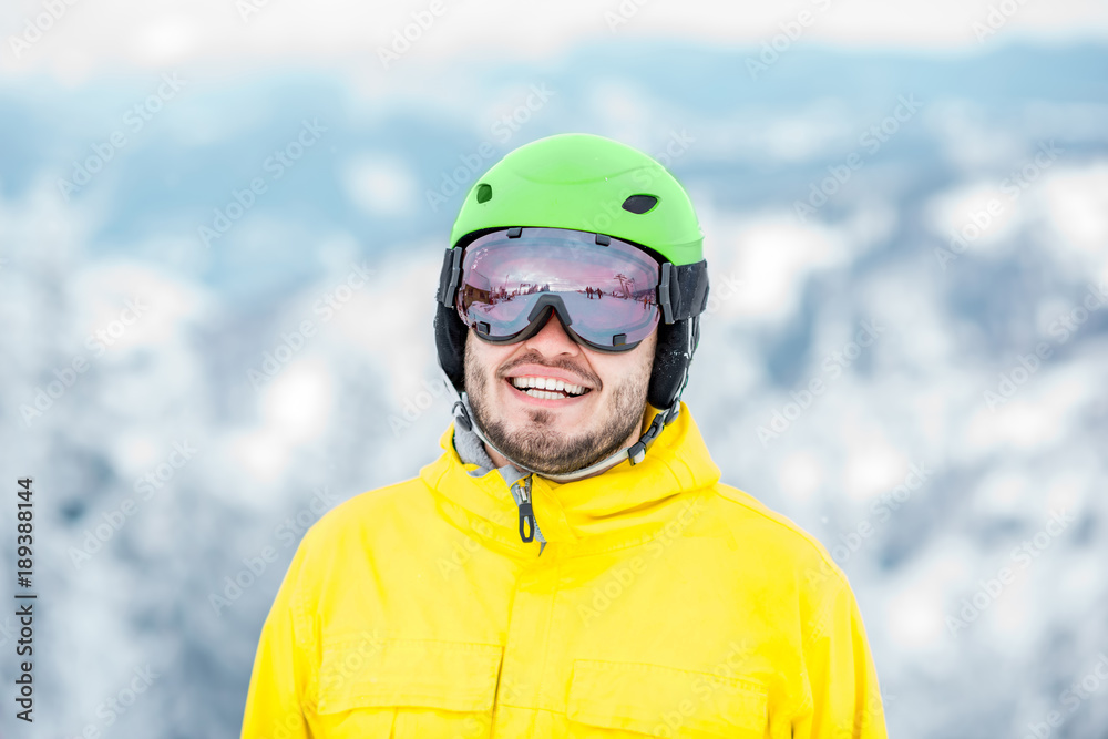 Portrait of a man dressed in snowboarding clothes outdoors at the mountains