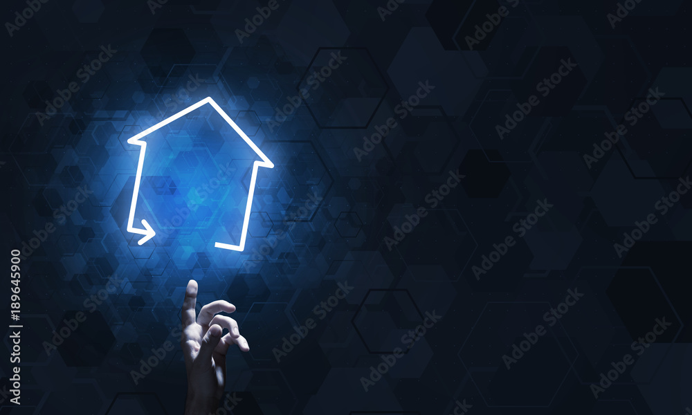 Conceptual image with hand pointing at house or main page icon on dark background