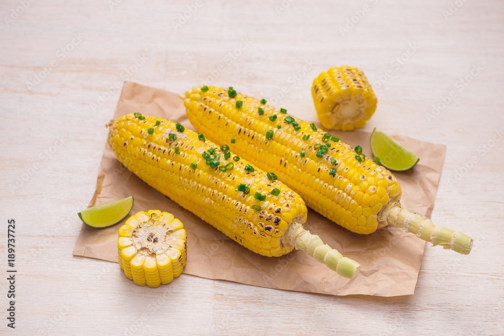 Delicious tasty grilled corn on wooden table