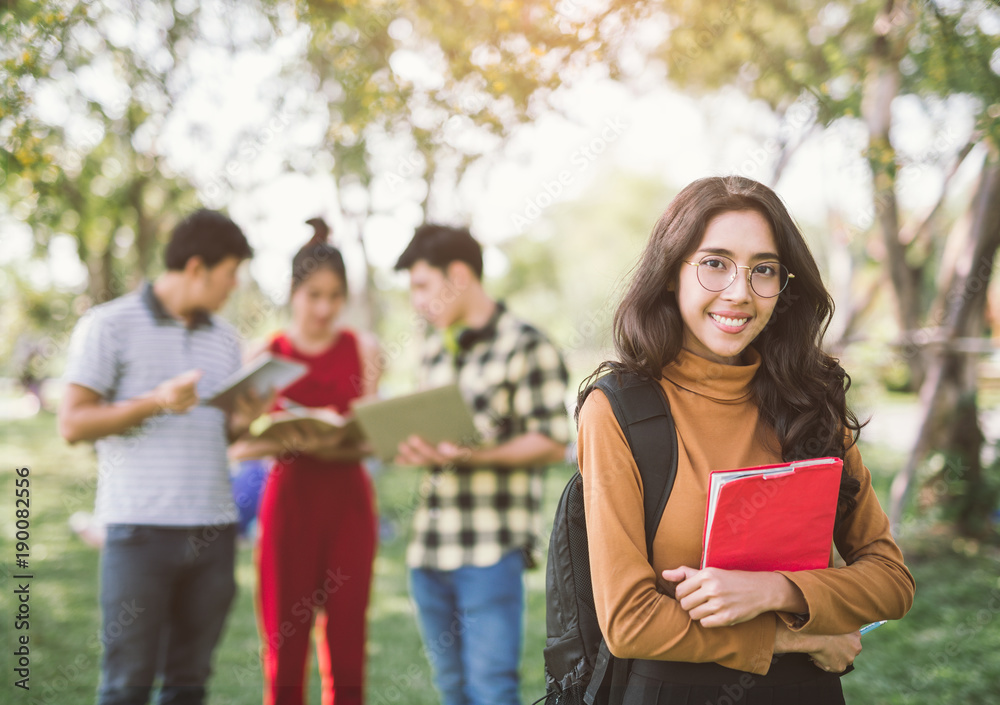 education, campus, friendship and people concept - group of happy asian teenage students with school