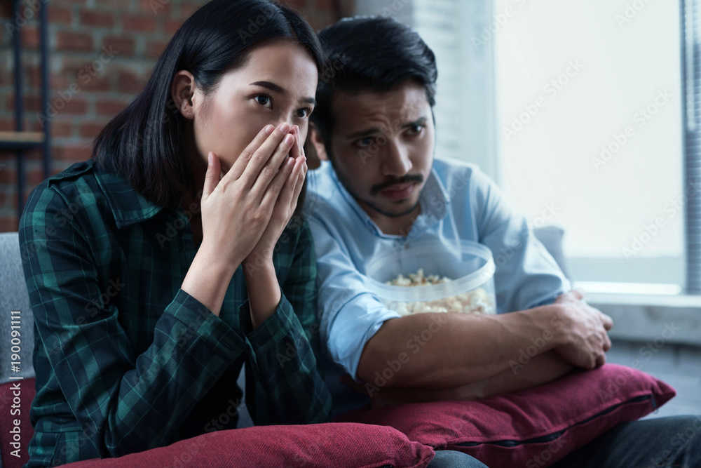 Couples are watching movies at home. Hes thrilled with the movie.