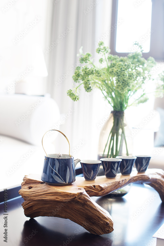 elegant tea pot and cup on table