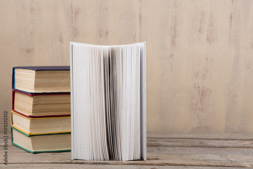 Education and reading concept - group of colorful books on the wooden table