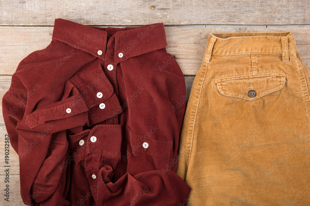 Dark red velveteen shirt on the wooden background