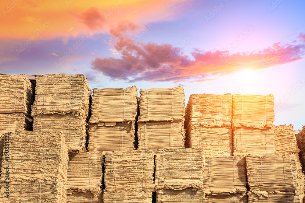 many cardboard raw materials are stacked in the factorys outdoor warehouse