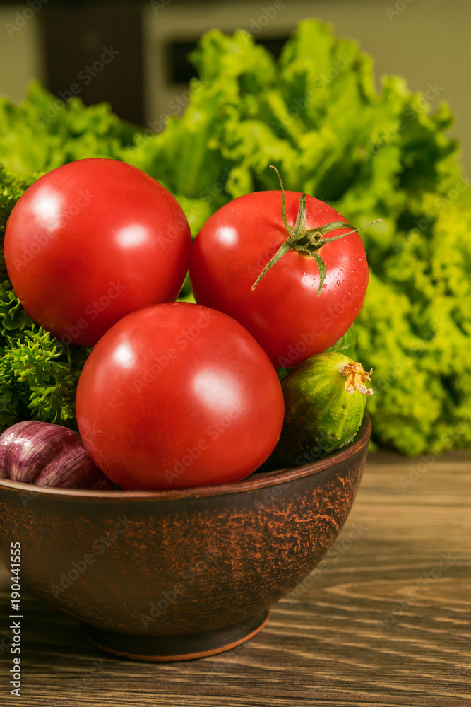 Fresh vegetables in a ceramic bowl on a rustic wooden table. The concept of a healthy diet