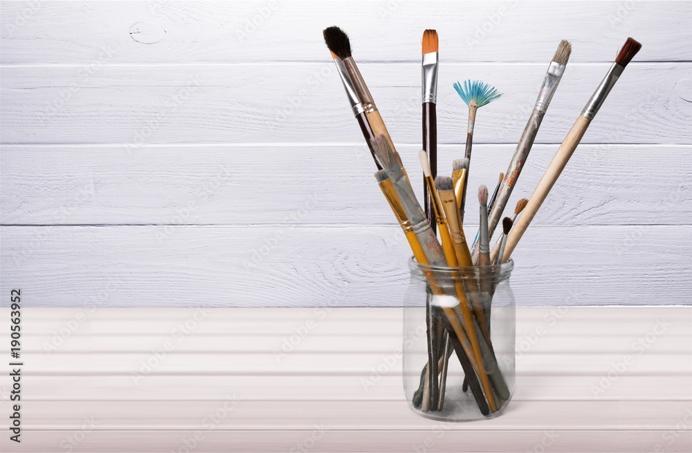 Brushes in a glass jar