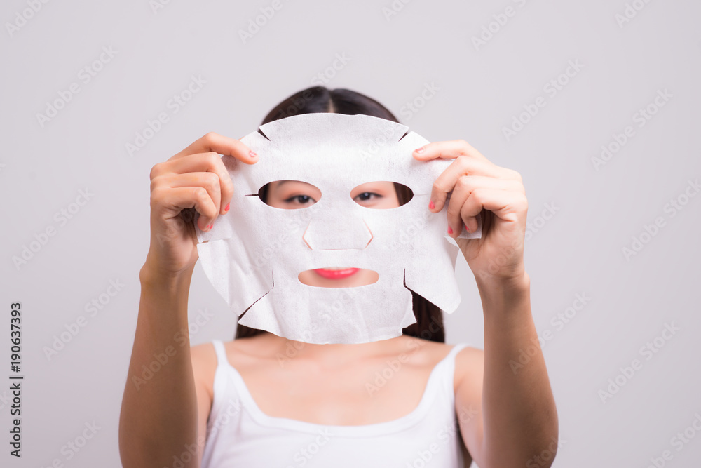 Face skin care. Woman with a cloth moisturizing mask on her face