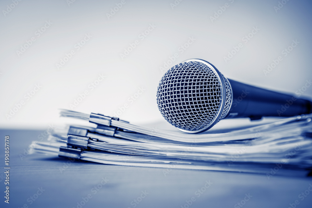 Close up a Microphone with paper document , concept of speaker or teacher preparation to speak in se