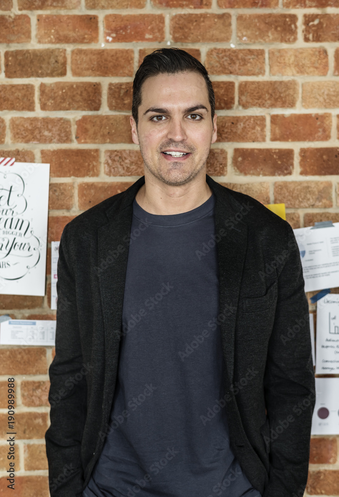 Portrait of Caucasian man against brick wall