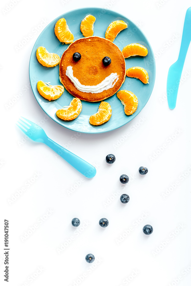 concept kid breakfast with pancake top view on white background