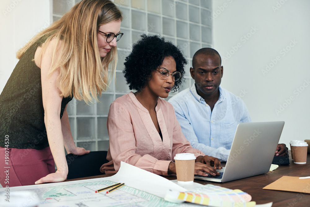 Colleagues working together online in a modern office