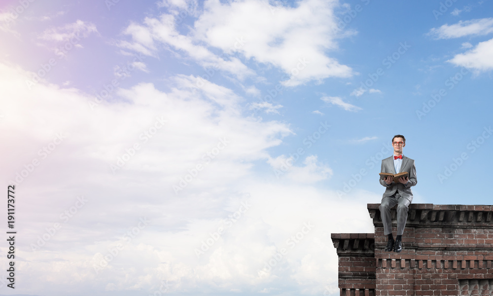 Young businessman or student studying the science on building roof