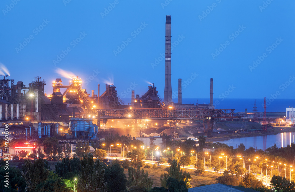 Metallurgical plant at night. Steel factory with smokestacks. Steelworks, iron works. Heavy industry