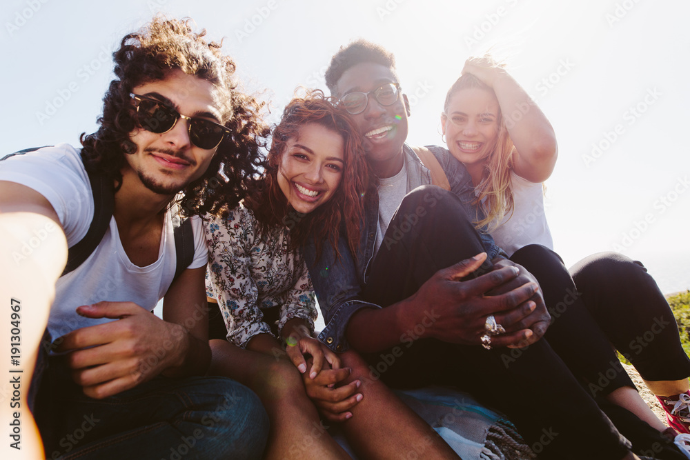 Smiling friends taking selfie on a holiday