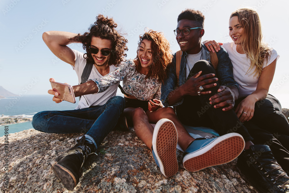 Friends on mountain top taking selfie