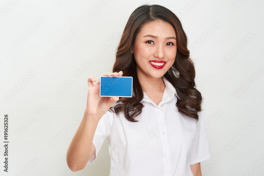 Portrait of a beautiful young woman showing blank credit card