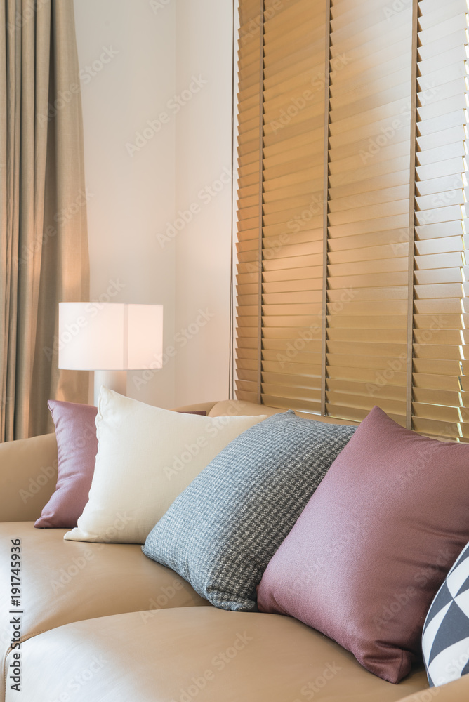 brown sofa with colorful pillows