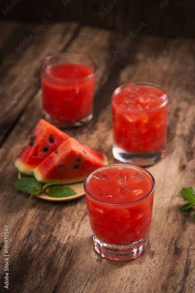 Refreshing summer watermelon juice in glasses with slices of watermelon