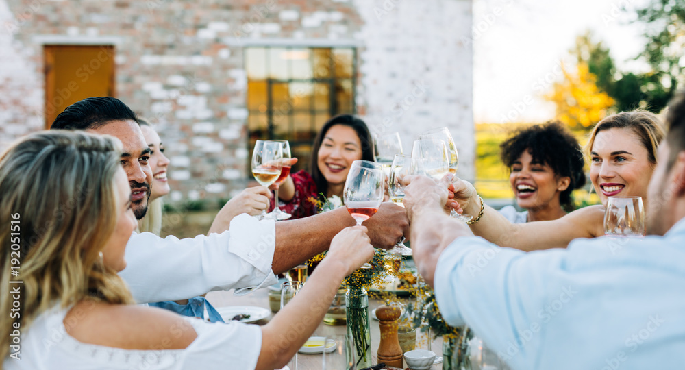 Group of people toasting wine at party