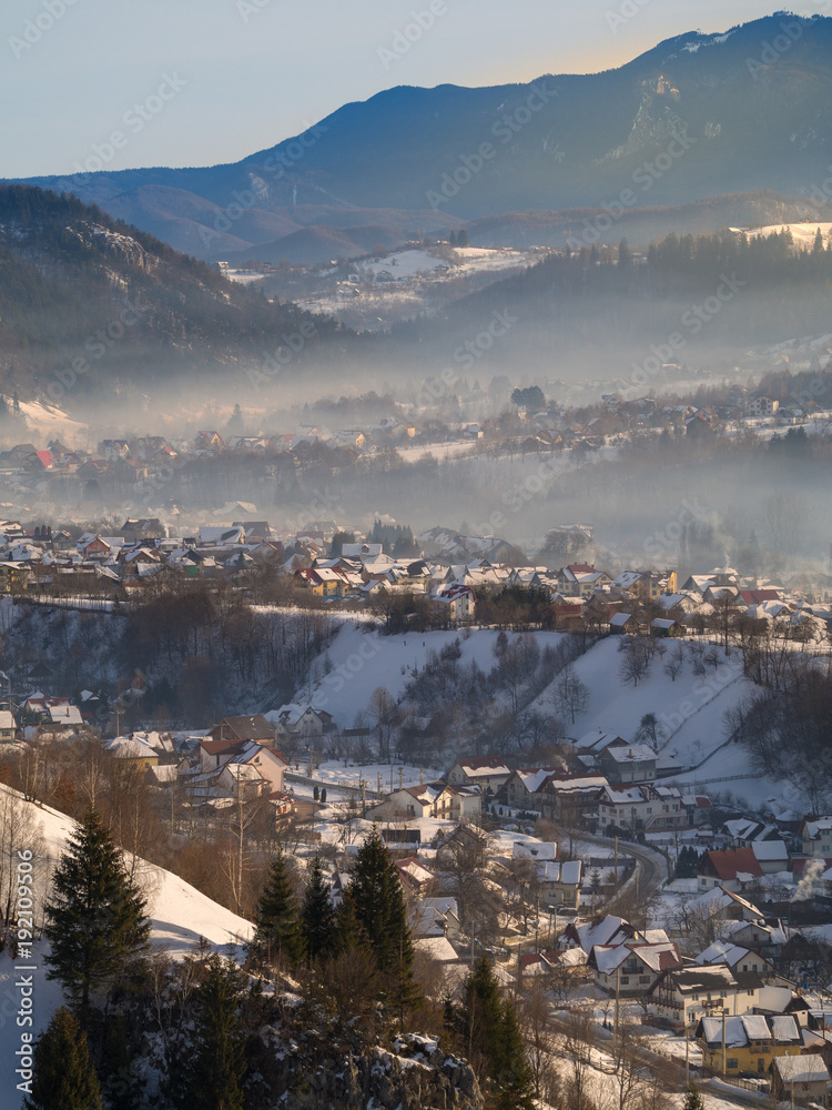 Winter rural scene in the mountains. Carpathians mountains, Romania. Countryside landscape in Transy