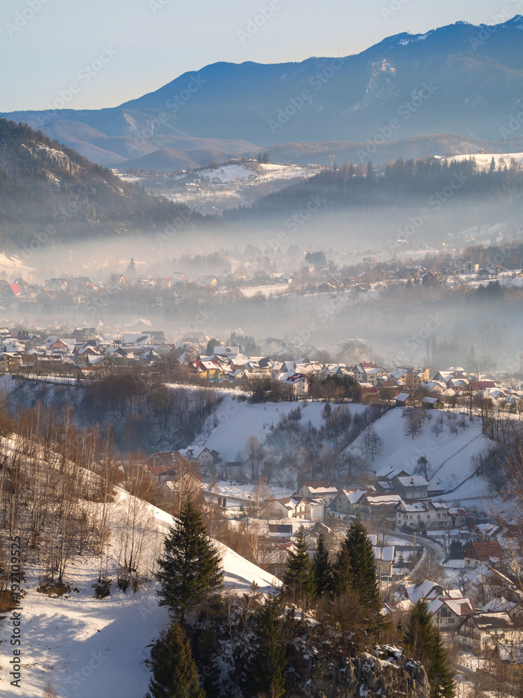 Winter rural scene in the mountains. Carpathians mountains, Romania. Countryside landscape in Transy